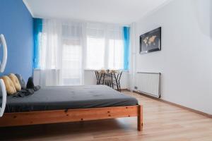 A bed or beds in a room at The Pearl of Esztergom