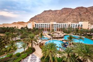 an aerial view of a resort with palm trees at Shangri-La Barr Al Jissah, Muscat in Muscat