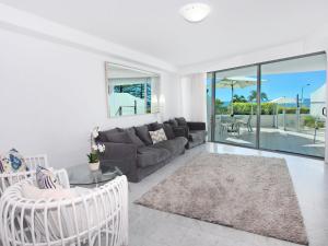 a living room with a couch and a table at Sirocco 202 in Mooloolaba