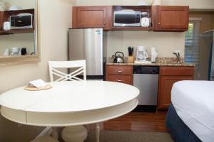 a small kitchen with a white table in a room at InnSeason Resorts HarborWalk in Falmouth