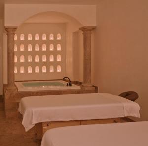 a bathroom with a bath tub and a sink at Casa Kimberly Boutique Hotel in Puerto Vallarta