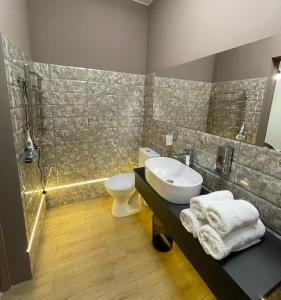 a bathroom with a sink and a toilet and a shower at Apart-Hotel у центрі Трускавця in Truskavets