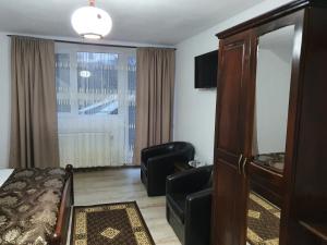 a hotel room with a bed and a window at Casa Destinatia Perfecta in Braşov