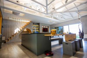 a large kitchen with a staircase and a table at Spa Villa Skaloma in Nafpaktos