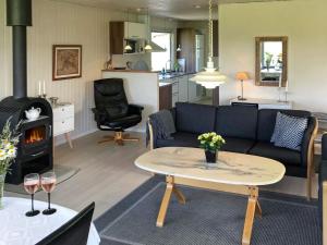 a living room with a couch and a table and a stove at Two-Bedroom Holiday home in Aabenraa 2 in Aabenraa