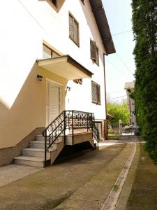 a white building with stairs and a door at Vila Nikola in Soko Banja