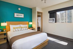 A bed or beds in a room at VIVE Hotel Waikiki