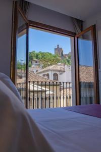 Una cama o camas en una habitación de Hotel Boutique Puerta de las Granadas