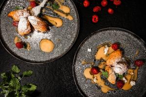 dos platos de comida con fresas en una mesa en Amrai Suites, en Schruns