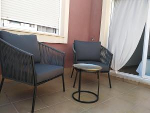 two chairs and a table next to a window at Sevilla Aljarafe Room in Bormujos