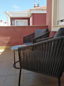 two chairs and a table on a balcony at Sevilla Aljarafe Room in Bormujos