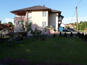 a house with a yard in front of it at Private Home Rifat in Dubrave Gornje