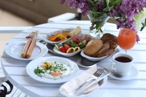 una mesa con una bandeja de alimentos para el desayuno. en Hotel Wodnik, en Giżycko