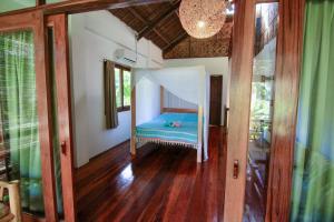 A bed or beds in a room at Ferra Resort Siargao