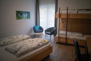 a bedroom with two bunk beds and a desk at Pension Yvonne - SUPERIOR in Rust