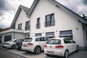 a group of cars parked in front of a building at Pension Yvonne - SUPERIOR in Rust