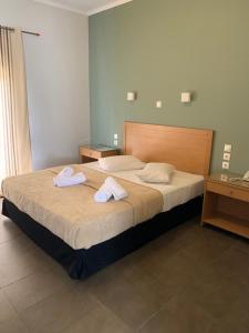 A bed or beds in a room at Alkistis Hotel