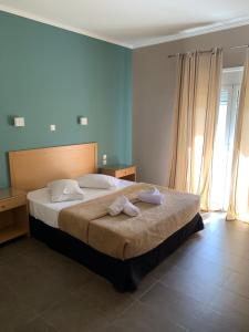 A bed or beds in a room at Alkistis Hotel