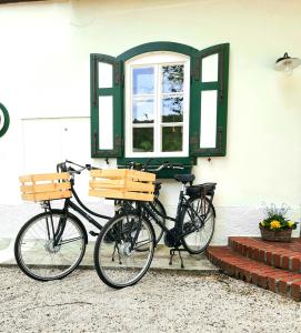 duas bicicletas estacionadas ao lado de um edifício com uma janela em LANDSITZ OBERHOF petit hôtel em Muggendorf