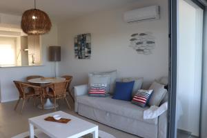 a living room with a couch and a table at ROOF TOP SEA VIEW ALVOR in Alvor