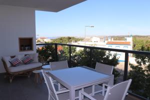 a balcony with a table and chairs and a view at ROOF TOP SEA VIEW ALVOR in Alvor