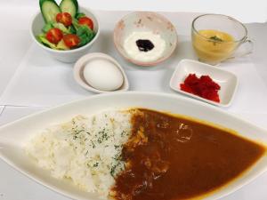 a plate of food with rice and a bowl of fruit at Smile Hotel Nagoya Sakae in Nagoya