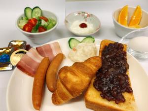 a plate of food with pastries and other foods at Smile Hotel Nagoya Sakae in Nagoya