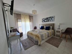 1 dormitorio con 1 cama y TV. en Refugio Praia da Rocha, en Portimão