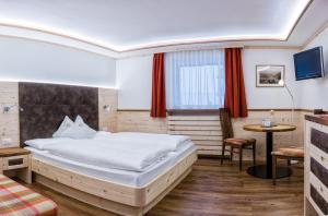 Hotel Garni Aghel में एक कमरे में एक या कई बेड