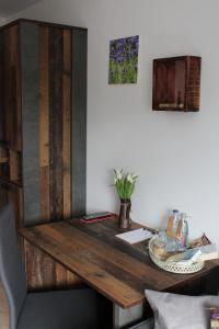 a wooden desk in a room with a table at Bachmeier's Gasthaus Traube Niederfell in Niederfell