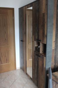 a room with two wooden doors and a hallway at Bachmeier's Gasthaus Traube Niederfell in Niederfell