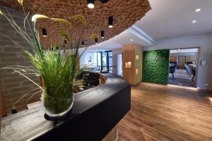 a lobby with a plant in a vase on a counter at Hotel Beethoven in Hinterbrühl