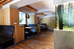 a restaurant with chairs and a table in a room at Hotel Beethoven in Hinterbrühl