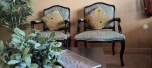 two chairs with pillows sitting next to a table at Hotel Sao Mamede in Estoril