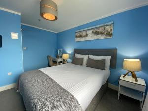 una camera blu con un letto e una parete blu di The Lyncroft a Newquay