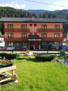 a large building with a green lawn in front of it at Residence Ables in Valfurva