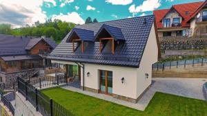 a rendering of a house with a blue roof w obiekcie Domki Nad Wodospadem w mieście Szczawnica