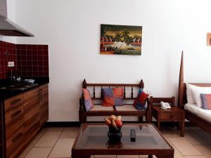 a living room with a couch and a table at Cowrie Shell Beach Apartments Official in Bamburi