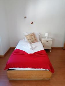 una camera con un letto con una coperta rossa di Portus Ribeira House a Vila Nova de Gaia