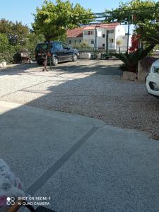 a shadow of a car parked in a driveway at Apartments Kule in Brela