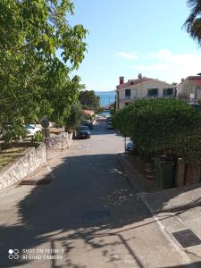 a street with cars parked on the side of the road at Apartments Kule in Brela