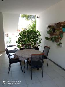 a table and chairs with a potted plant on a patio at Apartments Kule in Brela