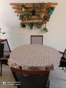 a table with chairs and potted plants on a wall at Apartments Kule in Brela