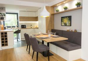 a kitchen and dining room with a table and chairs at Sea&City Deluxe Apartment - Top Center Varna in Varna City