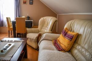 a living room with a couch and two chairs at Golden BIS, Subotica in Subotica