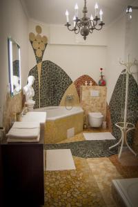 a bathroom with a tub and a sink and a toilet at Hotel Bojnický vínny dom in Bojnice