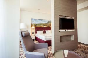 A television and/or entertainment centre at Lielupe Hotel SPA & Conferences by Semarah