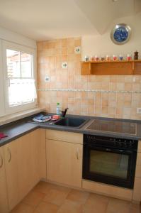 a kitchen with a sink and a stove at Ferienwohnung Heinrichseck in Bamberg