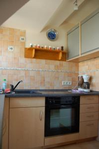 a kitchen with a sink and a stove top oven at Ferienwohnung Heinrichseck in Bamberg