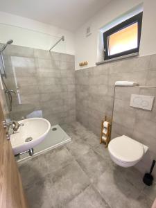 a bathroom with a sink and a toilet at Sport HOTEL Bečva in Valašské Meziříčí